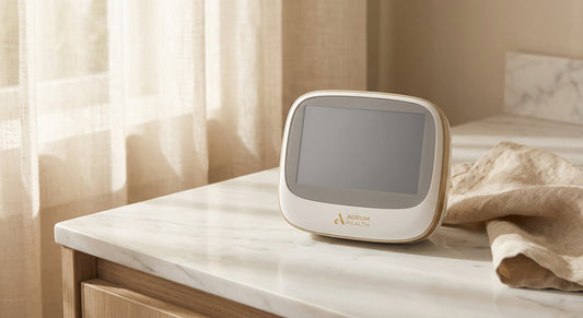 A clean, modern at-home medical testing kit resting on a white marble surface in warm natural light, evoking privacy and trusted personal healthcare.